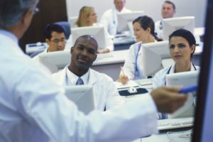 Doctors sitting behind computers